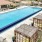 a swimming pool with a building in the background