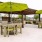 a group of tables and chairs under umbrellas
