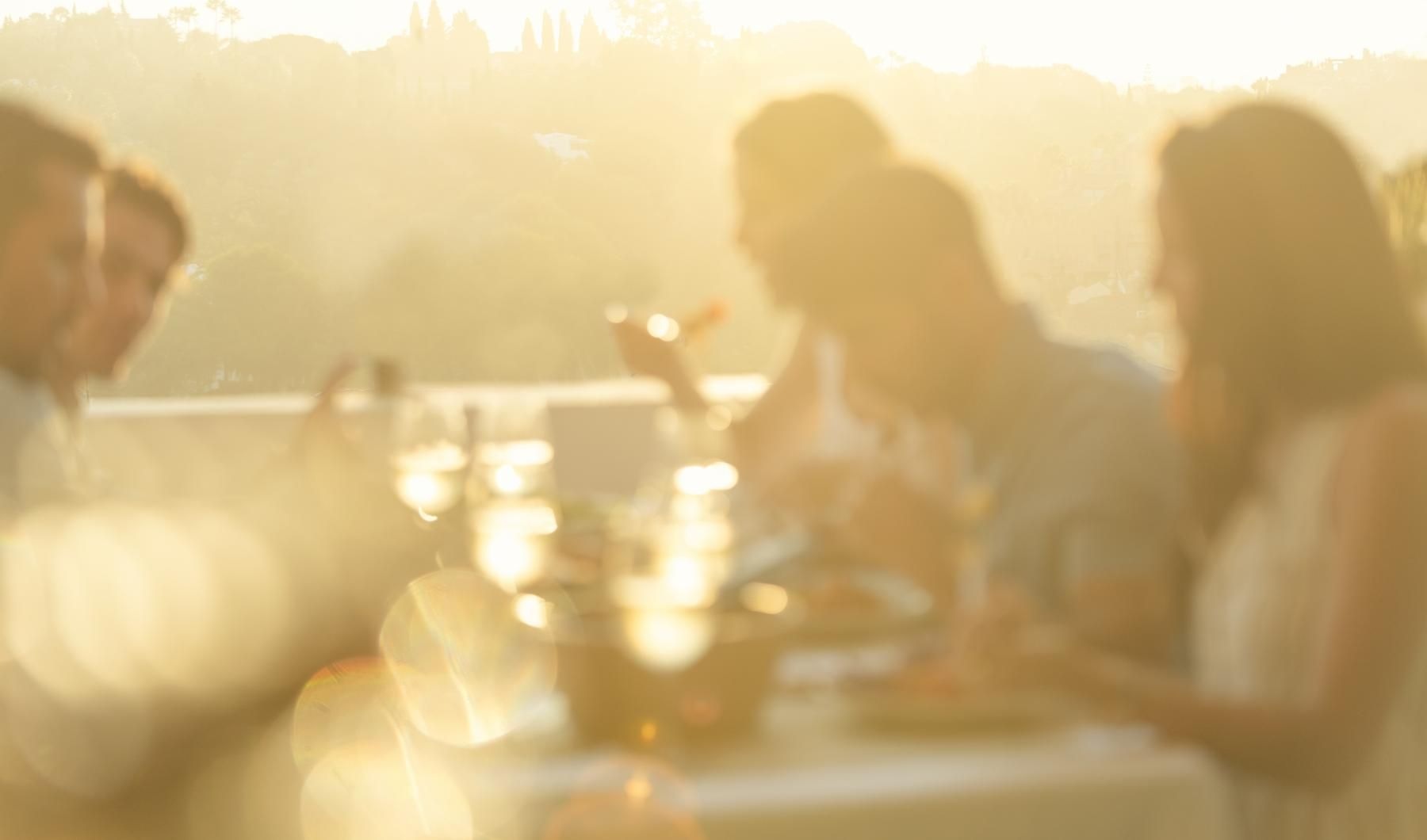 a group of people sitting at a table with a group of candles