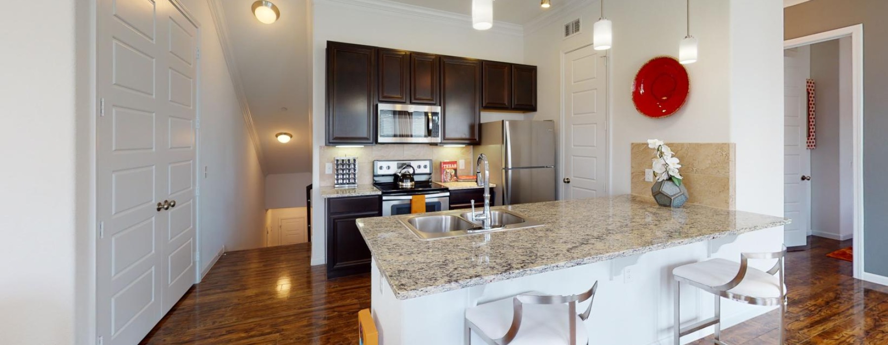 a kitchen with a marble island