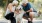 a man and woman petting a dog