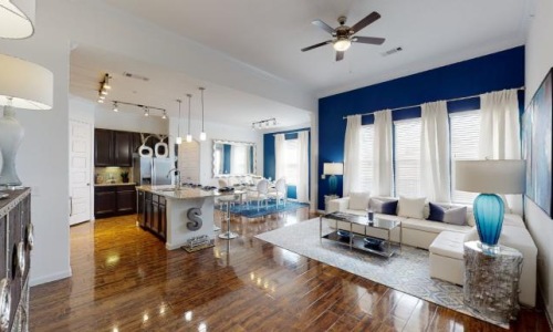 a large living room with a large blue wall